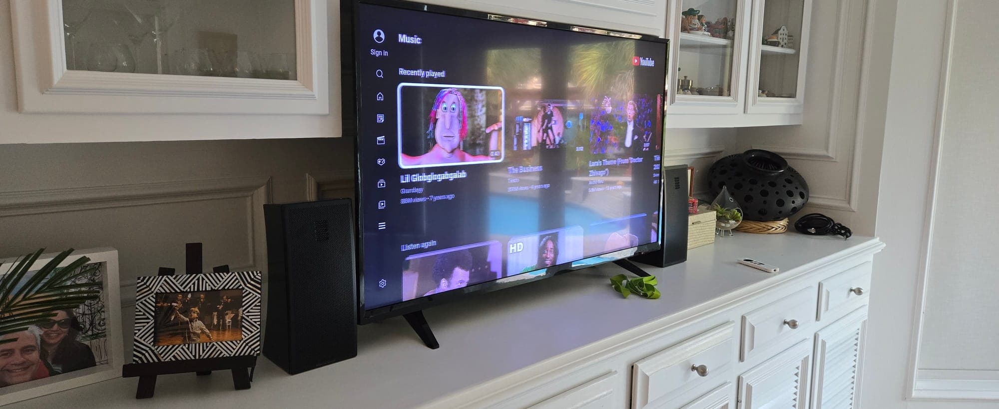 Living room media cabinet with a flat-panel TV and bookshelf speakers