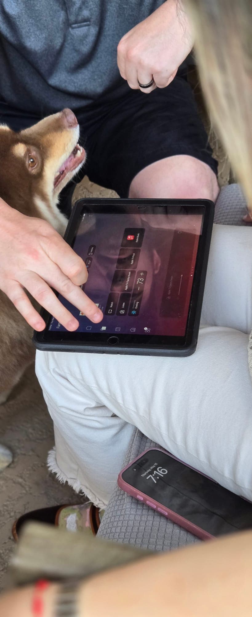 Homeowner controlling the smart home system from a tablet app