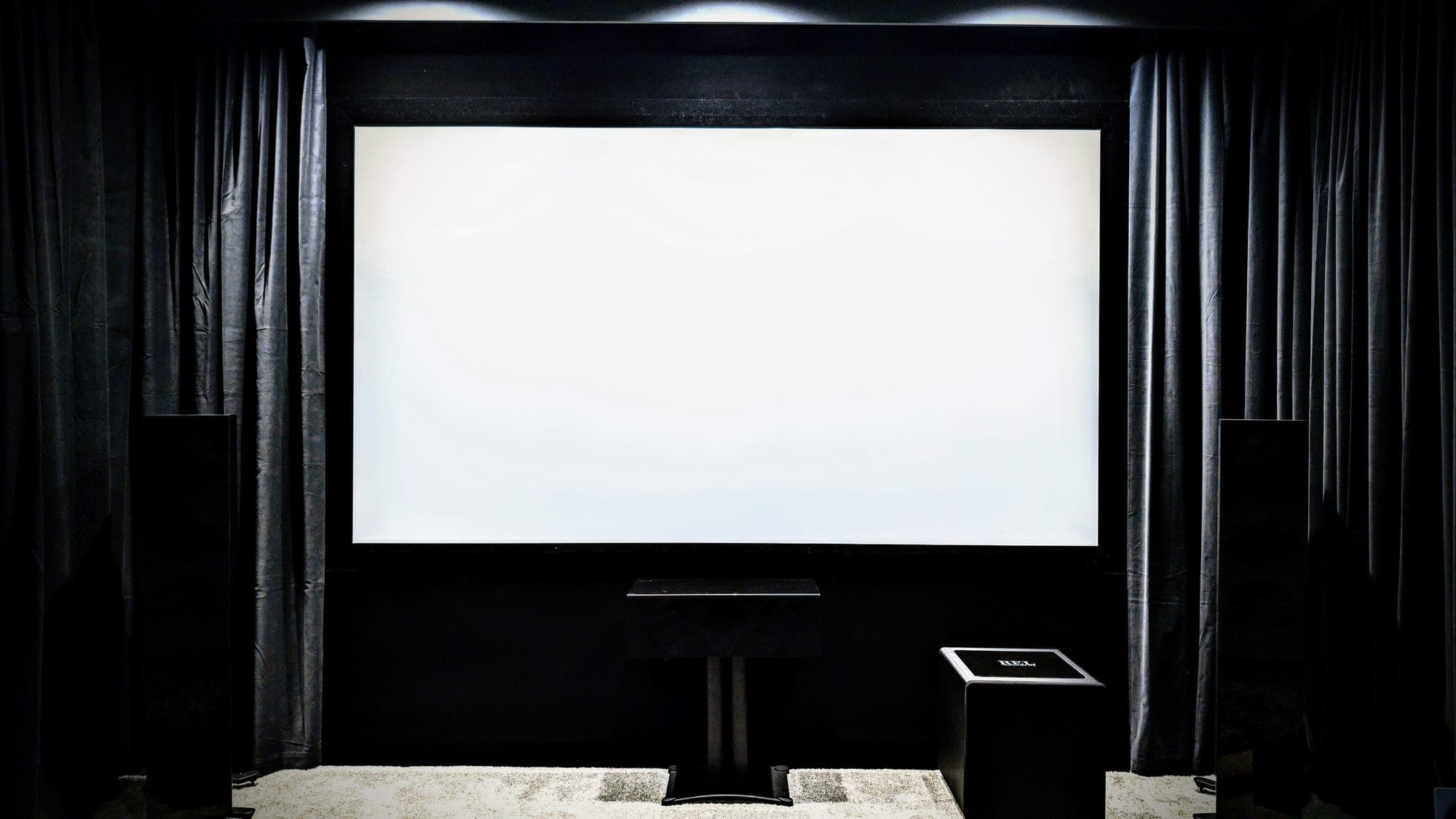 Dedicated cinema room with blackout curtains and tower speakers
