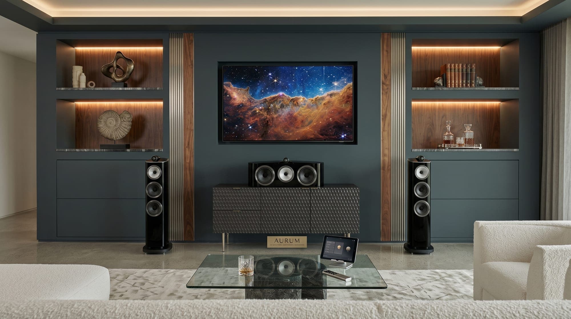 Living room media wall with a large flat-panel TV, tower speakers, and a center channel above a media console